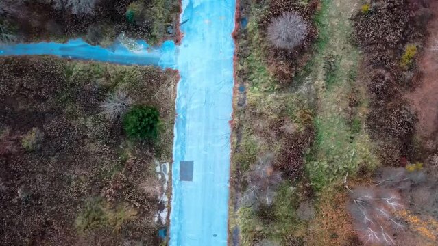 Aerial top down of graffiti road in Fall around abandoned coal town Centralia Pennsylvania