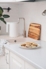 Cottage cheese fritters or syrniki served with syrop on kitchen table.