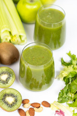 Healthy vegetable smoothie in glasses on white background.