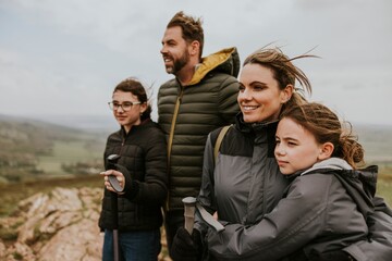 Family standing on mountain, outdoor activity