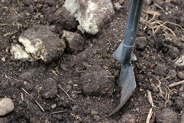 black garden soil and shovel