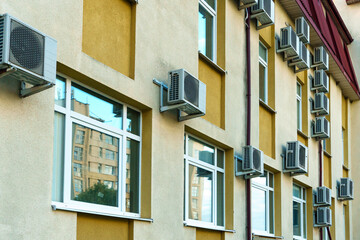 Outdoor air conditioning unit. A large modern air conditioner on the wall of an apartment building. Repair and maintenance of the air conditioning system