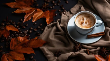 Coffee cup and autumn leaves on black background, top view