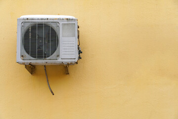 Outdoor air conditioning unit. A large modern air conditioner on the wall of an apartment building....