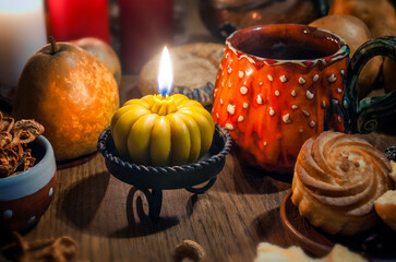 Space with lighted candle on a wooden table. Evening tea party. Halloween concept