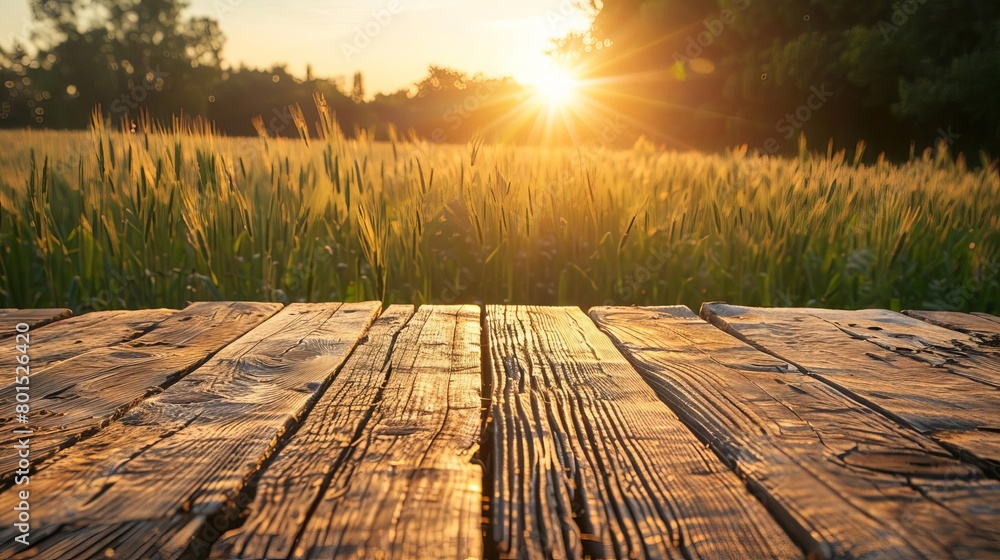 Wall mural rustic wooden table with prosperous farm landscape at sunset agriculture concept