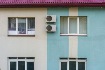 Outdoor air conditioning unit. A large modern air conditioner on the wall of an apartment building. Repair and maintenance of the air conditioning system