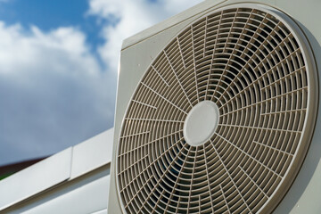 Outdoor air conditioning unit. A large modern air conditioner on the wall of an apartment building....