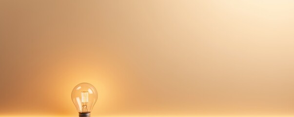 Tan backdrop with illuminated lightbulb on a white platform symbolizing ideas and creativity business concept creative thinking innovation new idea