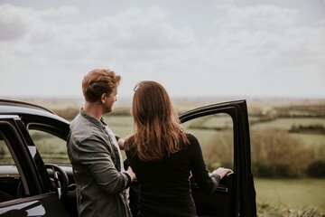 Couple on road trip, rear view photo