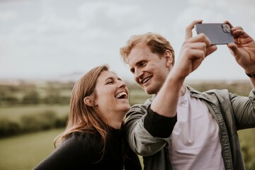 Happy tourist couple taking selfies