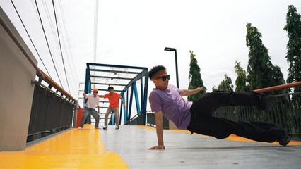 Panorama shot of hipster wearing stylish cloth and doing freeze pose. Group of professional dancer...