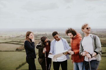 Group of friends traveling, looking at map photo