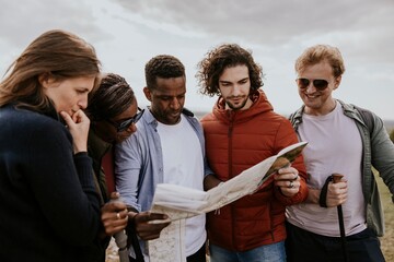 Group of friends looking at map photo