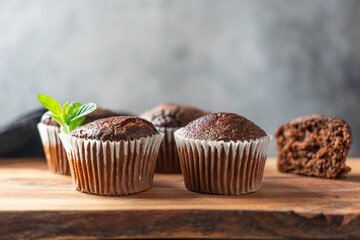 Chocolate muffins on a wooden stand. Close-up.