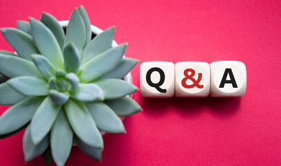 Q and A - Question and Answer. Wooden cubes with words Q and A. Beautiful red background with...
