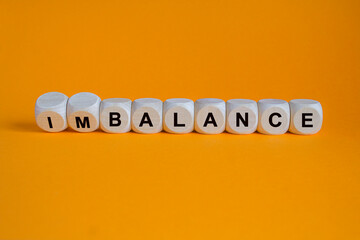 Balance or imbalance symbol. Turned wooden cubes and changes the word imbalance to balance....