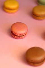 Colorful macarons on pink background. Selective focus.