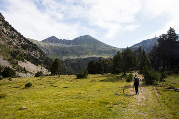 Fototapeta premium Young hiker woman in Vall de Boi, Aiguestortes and Sant Maurici National Park, Spain