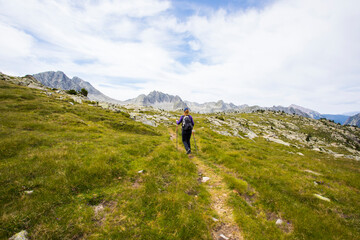 Fototapeta premium Young hiker woman in Vall de Boi, Aiguestortes and Sant Maurici National Park, Spain