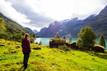 Women and Traditional houses in Lovatnet lake valley in Norway, Europe