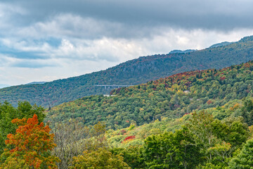 Grandfather Mountain new view Photo is from overlook on blue ridge parkway U can see Linville viaduct on the side going around a bolder field. At the top, the Mile High swinging bridge. Fall colors. 