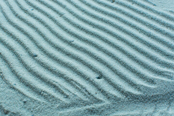 textured blue sand background, beautiful sand texture, overhead view of blue sand, zen pattern drawn in the sand, Top view of fine grain texture