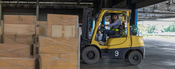 Man worker at forklift driver happy working in industry factory logistic ship. Man forklift driver...