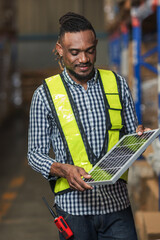 Man Worker holding a photovoltaic solar panel in warehouse. Happy Man with solar panel. Smiling worker holding a photovoltaic solar panel. holding power solar cell in warehouse