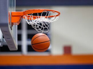 Basketball through hoop and net