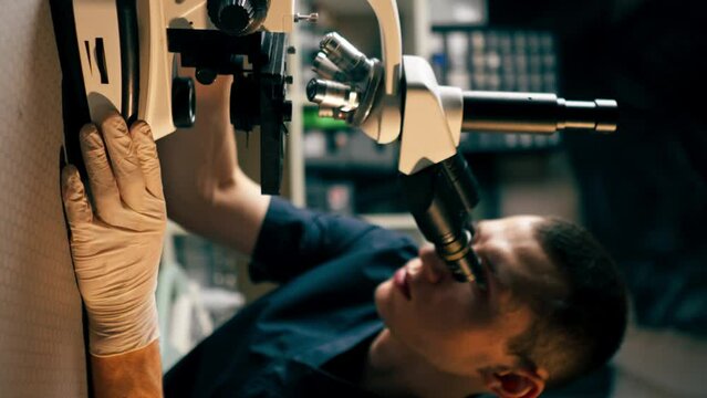 vertical video in a veterinary clinic a veterinarian doctor checks a smear for infections