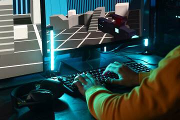 Man playing video games on computer indoors, closeup