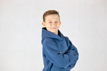 Portrait of a smiling boy in a hoodie, portrait of a boy