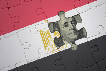 puzzle with the national flag of egypt and usa dollar banknote. finance concept