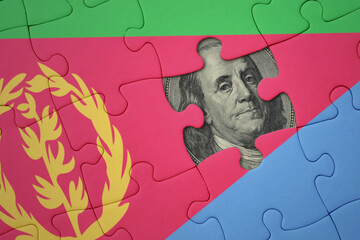 puzzle with the national flag of eritrea and usa dollar banknote. finance concept