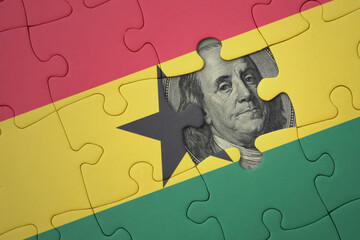 puzzle with the national flag of ghana and usa dollar banknote. finance concept