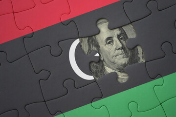 puzzle with the national flag of libya and usa dollar banknote. finance concept