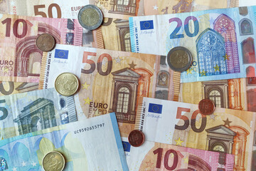 Stack of euro banknotes and coins
