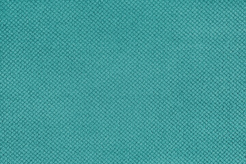 Plain turquoise velor upholstery fabric, jacquard with fine diamond texture background. Close up, macro cloth textile surface. Wallpaper, backdrop with copy space