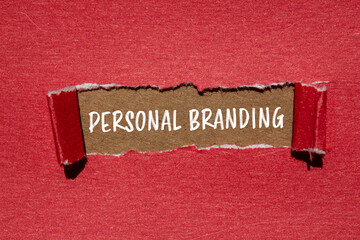 Personal branding words written on ripped red paper with brown background. Conceptual personal...