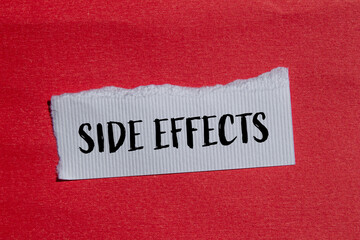 Side effects words written on ripped white paper with red background. Conceptual side effects...