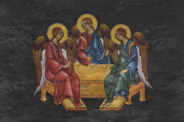 Christian traditional image of the Holy Trinitian. Religious illustration on black stone wall background in Byzantine style