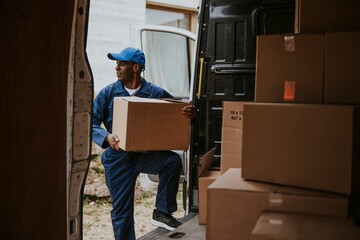 Removal service worker unloading box from the van