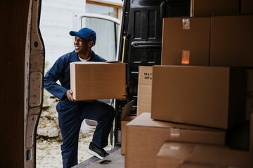 Removal service worker unloading box from the van
