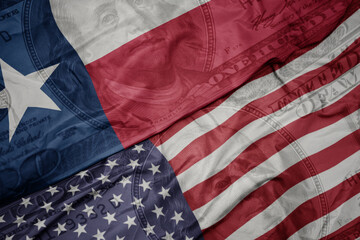Obraz premium waving colorful flag of united states of america and flag of texas state on the dollar money background. finance concept.