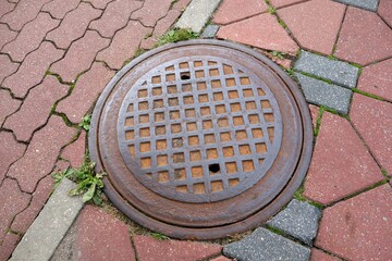 Old manholes , inlets of the septic tank , sewer in a new sidewalk