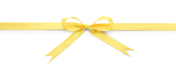 Fototapeta premium Yellow satin ribbon with bow on white background, top view