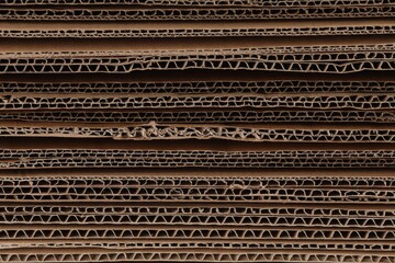 Sheets of brown corrugated cardboard as background, closeup