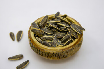 Salted sunflower seeds in a wooden bowl