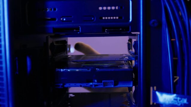 Computer technician uninstalling hard disk out PC case. Assemble computer system unit to a modern workstation. Upgrading Rendering and gaming computer hardware components 